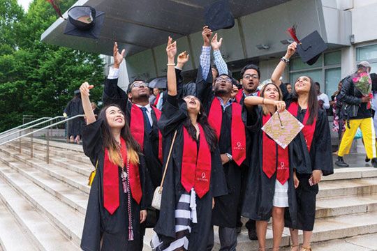 A group of pass out students watching to the sky