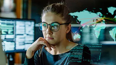 A female student studying in the computer lab