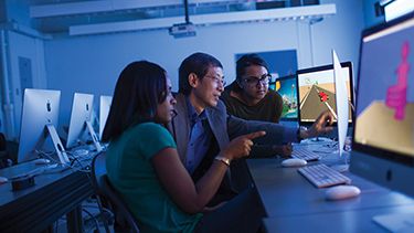 Students watching on the computer screen in the lab