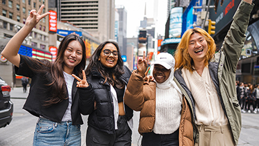 Students making victory sign outside in the campus