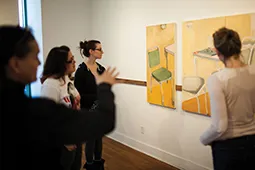 Students watching paintings in the art studio