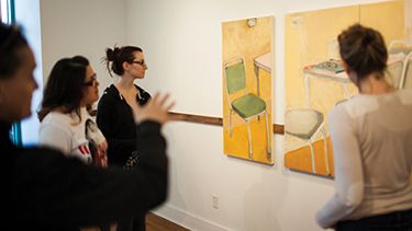 Students watching paintings in the art studio