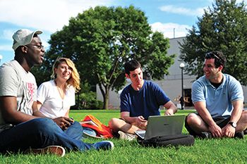 A group of student sitting outside in the garden